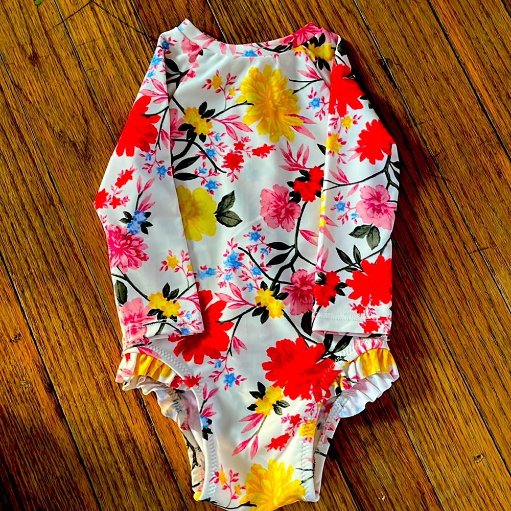 Long sleeve infant girl one piece swimsuit.